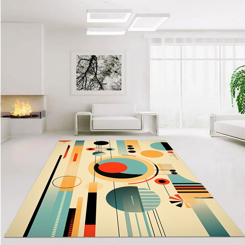 May include: A rectangular area rug featuring a cream background with a geometric pattern of circles, lines, and rectangles in shades of teal, orange, black, and yellow. The design includes various solid shapes and striped elements arranged across the surface.