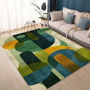 May include: A rectangular area rug featuring a geometric pattern of overlapping circles, semicircles, and rounded bars in shades of forest green, teal, olive, mustard yellow, and cream, with a subtle textured finish across the entire surface.