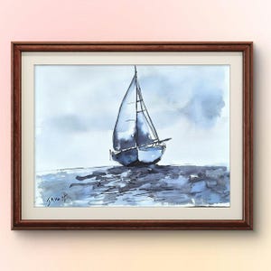 May include: Watercolour painting of a sailboat on the water, framed in a dark brown wooden frame. The sailboat is white and blue, with a dark blue mast and sails. The water and sky are shades of blue and grey.