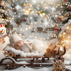 May include: A sleeping baby wearing a white knitted hat and a white knitted outfit is lying on a wooden sled covered in white faux snow. The sled is decorated with a pine cone and a wooden log. The background is a snowy winter scene with a snowman and a small wooden house.