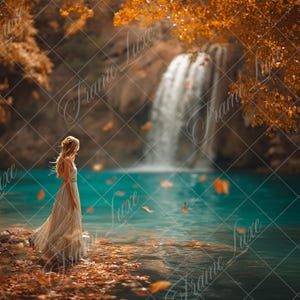 May include: A person with long blonde hair wearing a flowing, light-colored sleeveless dress stands on a rocky shore covered in fallen orange leaves. The scene features a turquoise pool of water and a waterfall in the background with autumn trees.