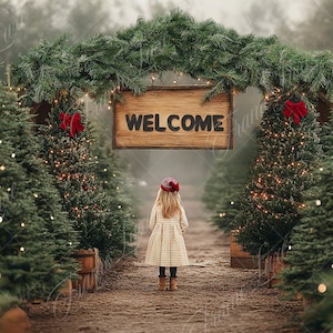 May include: A young girl in a plaid dress and red hat stands in front of a wooden sign that reads "WELCOME". The sign is decorated with evergreen branches and red bows. The girl is surrounded by Christmas trees decorated with lights.