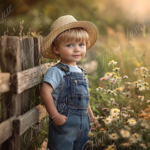 May include: A young child wearing a straw hat and blue overalls stands next to a wooden fence in a field of wildflowers.
