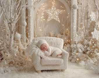 May include: A newborn baby wearing a white knit outfit and hat, sleeping peacefully in a small, cream-colored armchair. The scene is set in a winter wonderland with white trees, faux snow, and soft lighting, creating a cozy and serene atmosphere.