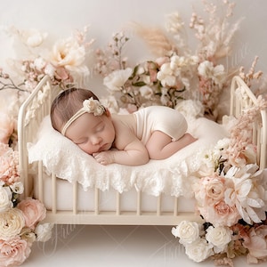 May include: A newborn baby girl sleeping on a white, lace-covered cot with a white headband and a white nappy. The cot is surrounded by a variety of pink and white flowers.