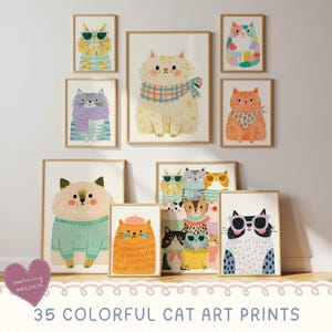 May include: A collection of framed art prints featuring various illustrated cats in colourful jumpers, scarves, and sunglasses. The artwork displays diverse feline characters with distinct patterns and accessories, arranged in a gallery wall layout.