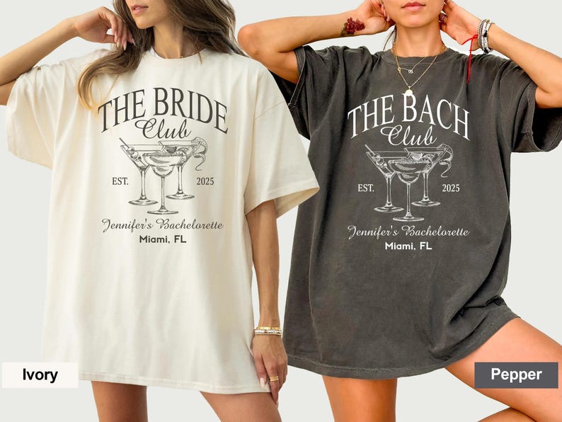May include: Two oversized t-shirts, one cream and one charcoal, featuring the text "THE BRIDE CLUB" and "THE BACH CLUB" respectively. Each shirt has a martini glass graphic, the year "2025", and "Jennifer's Bachelorette, Miami, FL".
