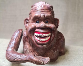 Piggy bank for coins,Bigfoot piggy bank metal cast iron mechanical. Swallows coins.