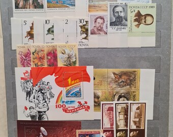 May include: A collection of vintage Soviet Union postage stamps featuring various themes, including space exploration, nature, and historical figures. The stamps are arranged in rows on a white background. The text "ПОЧТА СССР 1989" is visible on several of the stamps.