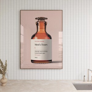 Puede incluir: Una botella de vidrio marr&oacute;n con una etiqueta que dice "Extra Salty Formula Men's Tears Ethically sourced from bruised male egos. 100% organic 30ml".