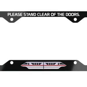 May include: Black license plate frame with the text "PLEASE STAND CLEAR OF THE DOORS." A white and red monorail train graphic is at the bottom. The frame has four mounting holes.