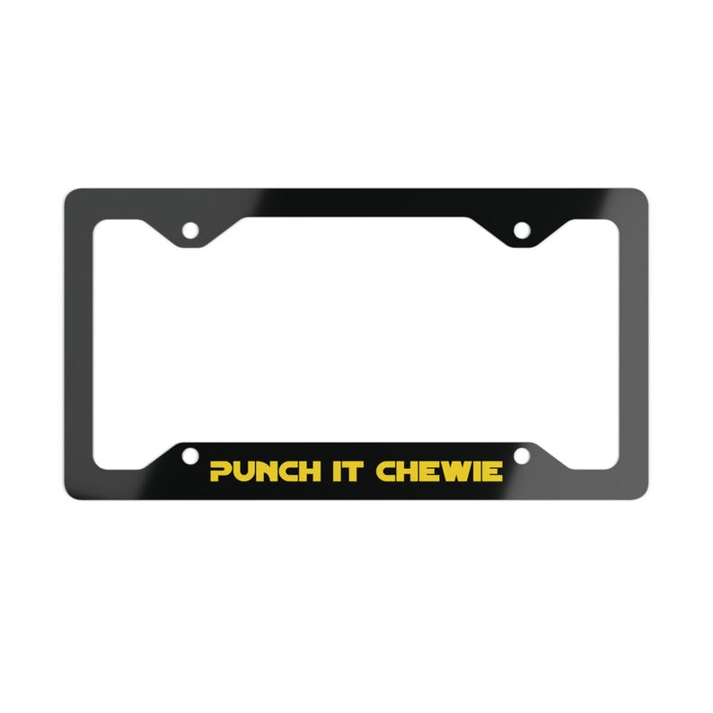 May include: A rectangular black license plate frame featuring four mounting holes. The bottom horizontal bar displays the text PUNCH IT CHEWIE in bold, yellow, sans-serif capital letters centered against the black background.
