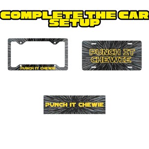 May include: A set of car accessories featuring a black and white hyperspace starfield pattern. The set includes a license plate frame, a rectangular license plate, and a rectangular decal, all displaying the yellow text PUNCH IT CHEWIE.