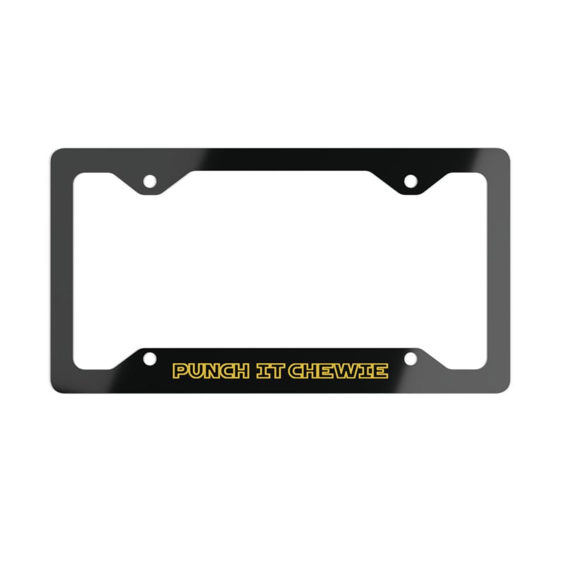 May include: A rectangular black license plate frame with four mounting holes. The bottom horizontal bar features the text PUNCH IT CHEWIE printed in a bold, yellow, outlined sans-serif font centered across the lower section of the frame.