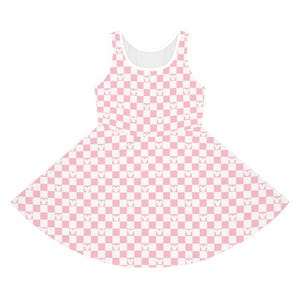 May include: A sleeveless skater dress featuring a pink and white checkered pattern. The pattern incorporates small Mickey Mouse head silhouettes within each square. The dress has a white neckline and armhole trim.
