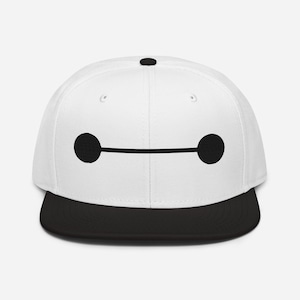 May include: White baseball cap with a black peak. The cap has a black embroidered design of two circles connected by a horizontal line, and a small black circle on top.