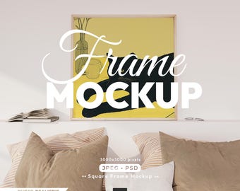 May include: Square frame mockup with a yellow and black cat illustration. The frame is displayed above pillows and a shelf with books. The image includes the text "Frame MOCKUP" and "PHOTO REALISTIC MOCKUP".