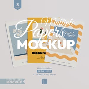 May include: A mockup featuring three paper designs with coastal themes. The papers display the words "COAST MOOD", "OCEAN W", and "Coastal mood". The image also includes the text "Multiple Papers Mockup", "3 Papers", and "Photo Realistic Mockup".