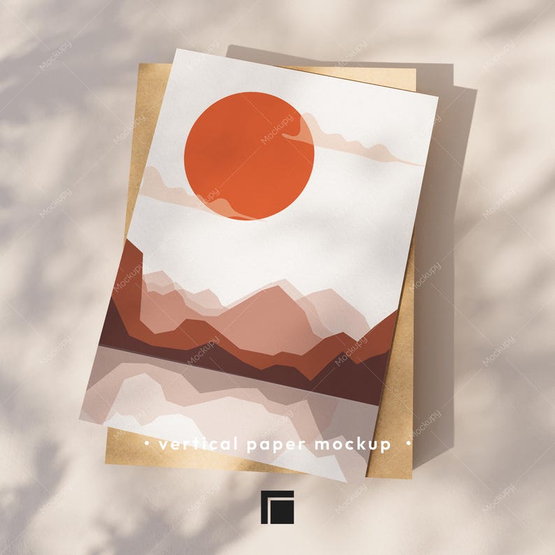 Op de afbeelding: Een verticale papieren mockup met een abstract landschapsontwerp. Het kunstwerk bevat een grote oranje zon, gelaagde bruine bergen en een reflecterend waterelement. De tekst "vertical paper mockup" staat onderaan.