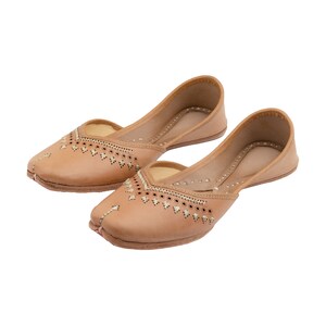 May include: A pair of tan leather shoes with intricate embroidery and decorative stitching. The shoes have a pointed toe and a low heel.