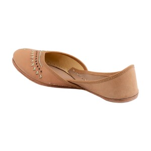 May include: Tan leather flat shoes with decorative stitching and cutouts. The shoes have a pointed toe and a low heel.
