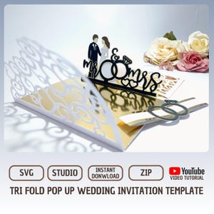 May include: A tri-fold pop-up wedding invitation template. The invitation features a laser-cut design with the words "Mr & Mrs" and two rings. The invitation is white and gold with a decorative floral design. The image also includes the words "SVG", "Studio", "Instant Download", "Zip", and a YouTube video tutorial icon.