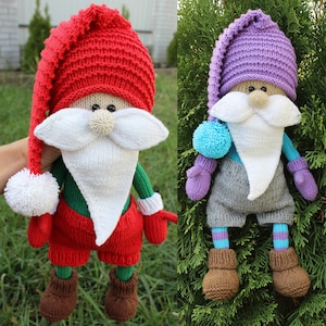 May include: Two knitted gnome dolls, one in red and white and the other in purple and grey. Both gnomes have white beards and brown boots.