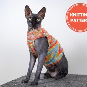 May include: A black hairless cat wearing a colorful striped knitted sweater. The sweater has a button closure and is designed for pets. The cat is sitting on a gray surface. The text "Knitting Pattern" is visible in a red circle in the upper right corner of the image.