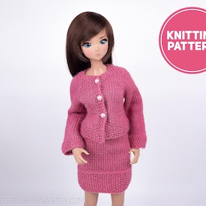 May include: Knitting pattern for a pink cardigan and skirt set for a doll. The set features a button-up cardigan with long sleeves and a matching skirt.