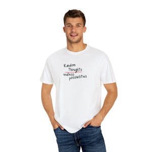 May include: White t-shirt with a black graphic that says "Random Thoughts" with a line drawn through "Thoughts" and "endless possibilities" written below.