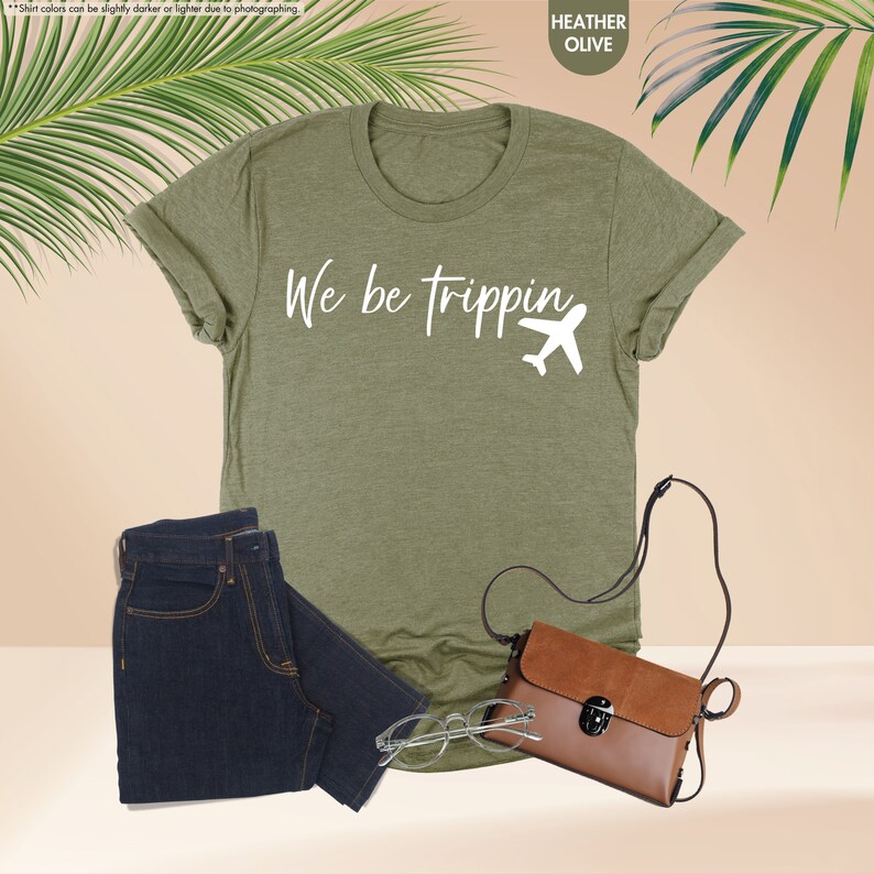 a t - shirt with the words we be tripping on it next to a
