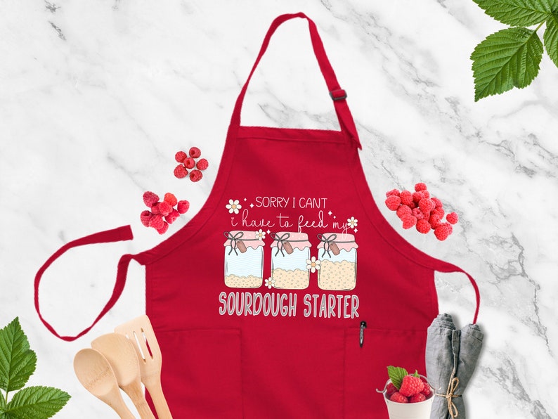 a red apron that says sorry i can't make it like a sourdou