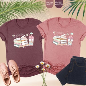 a couple of t - shirts that are next to a plant