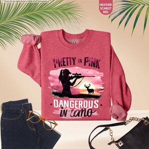 a pink shirt that says pretty in pink, with a silhouette of a woman holding