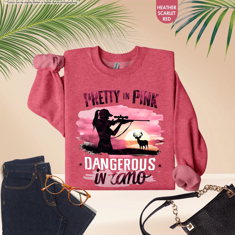 a pink shirt that says pretty in pink, with a silhouette of a woman holding
