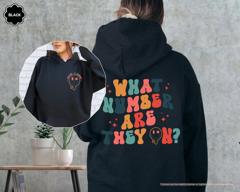 a woman wearing a black hoodie with what kind of are they? on it