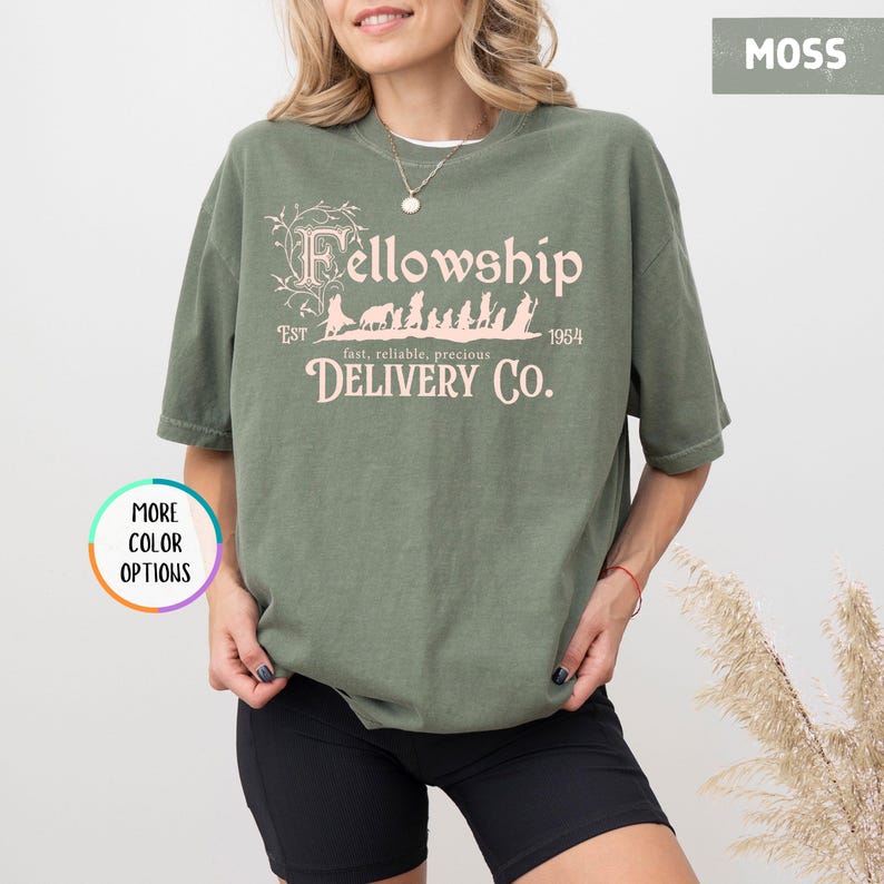 May include: A green t-shirt with a pink graphic of a group of figures walking with the text "Fellowship Est 1954 fast, reliable, precious DELIVERY CO."