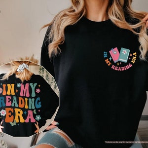 a woman wearing a black shirt with the words in my reading bra on it