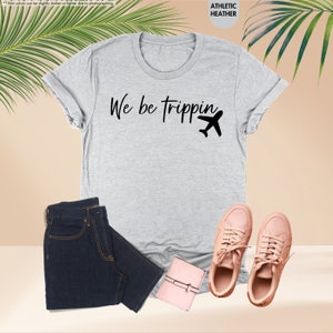 a t - shirt with the words we be trippin on it