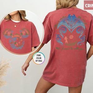 May include: A red t-shirt with a blue and green floral design on the front and a blue and green design with the text "There is nowhere you can go that I won't be with you" on the back.