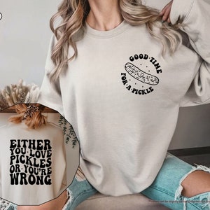 a woman wearing a sweatshirt that says, either you love pickles or you '