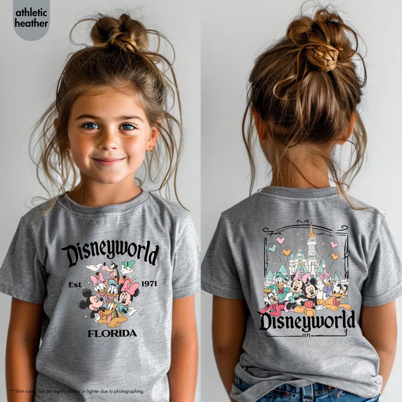 May include: A gray t-shirt featuring the text "Disneyworld" with the year "1971" and the word "Florida". The front of the shirt displays a graphic of Disney characters. The back of the shirt has a graphic of the Disney castle and characters.