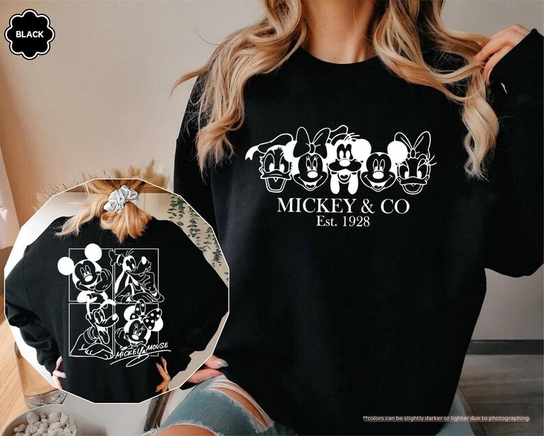 May include: Black sweatshirt featuring a white graphic of Mickey Mouse and friends, with the text "MICKEY & CO Est. 1928". The back of the sweatshirt also has a white graphic of Mickey Mouse and friends.
