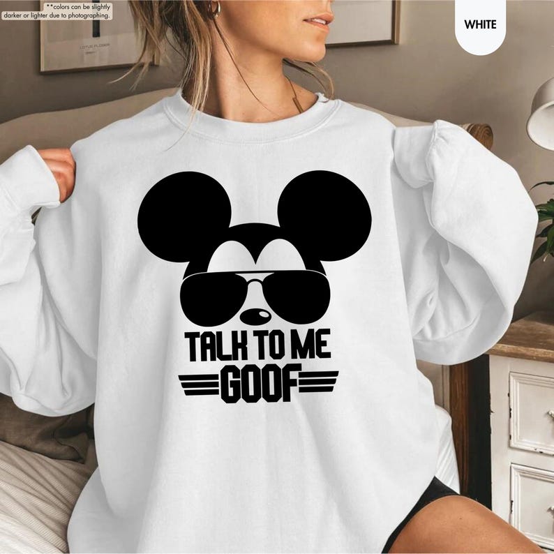 May include: White sweatshirt with a black Mickey Mouse graphic wearing sunglasses and the text "TALK TO ME GOOF". The long-sleeved sweatshirt has a crew neck and is made of a soft material.