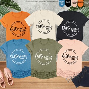 a group of women's t - shirts sitting on top of a wooden floor
