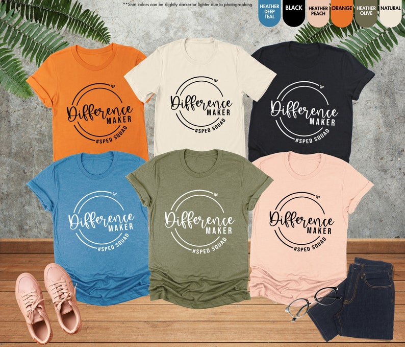 a group of women's t - shirts sitting on top of a wooden floor