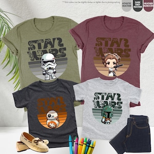 May include: Three t-shirts with a Star Wars theme. The shirts feature a retro-style sunset graphic with a different Star Wars character on each shirt. The characters are Stormtrooper, Princess Leia, and Boba Fett.