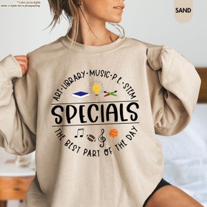 a woman wearing a sweatshirt with the words specials on it