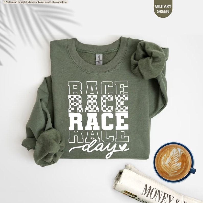 a t - shirt that says race race race day next to a cup of coffee