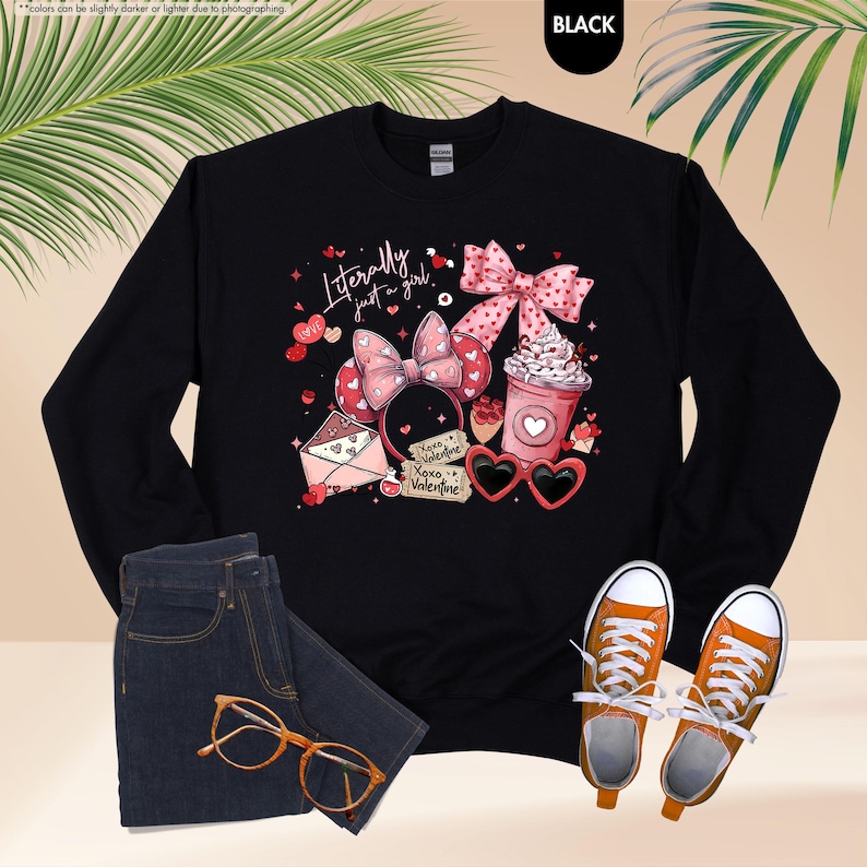 May include: Black sweatshirt with a graphic design including a pink bow, heart-shaped sunglasses, and the text "Literally just a girl." The design also features hearts, a coffee cup, and "Xoxo Valentine."